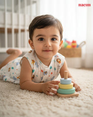 Child playing with a colorful wooden toy on a carpeted floor, with 'naeim' branding visible.