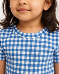 Close-up of a child wearing a blue and white checkered shirt