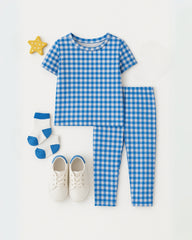 Blue gingham children's outfit with shoes and socks on a white background