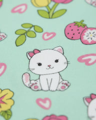 Fabric with a cartoon cat, flowers, and hearts on a light green background