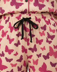 Pajama set with pink butterfly pattern on a beige background