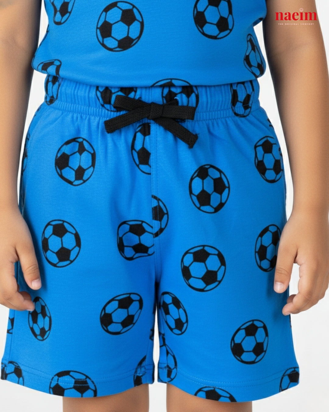 Child wearing a blue outfit with soccer ball patterns on a white background