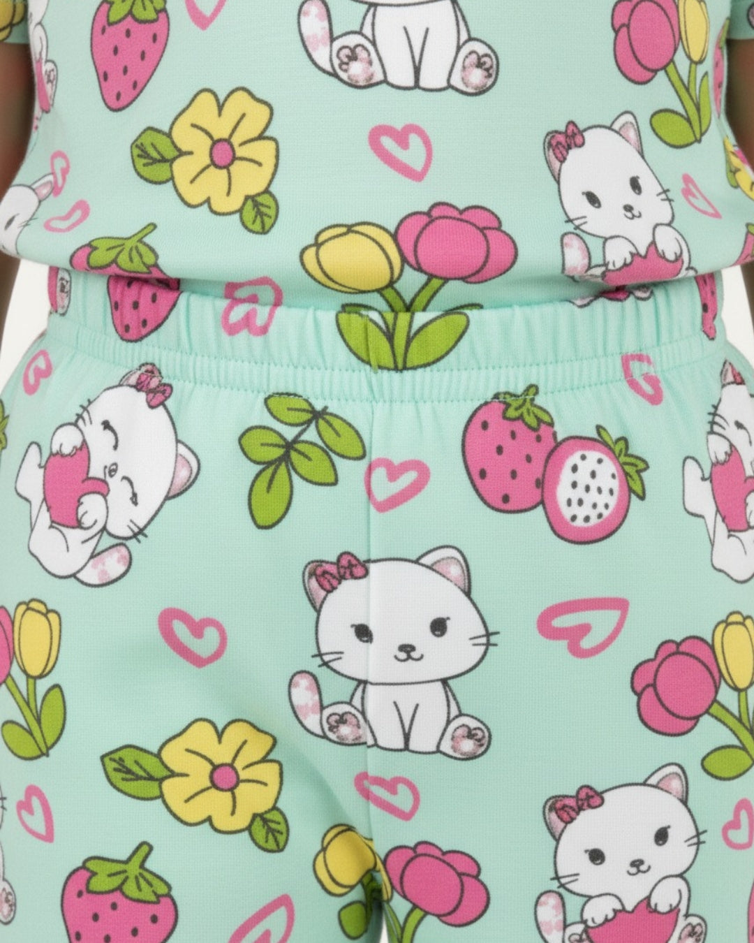 Children's outfit with cat and flower pattern on a light blue background