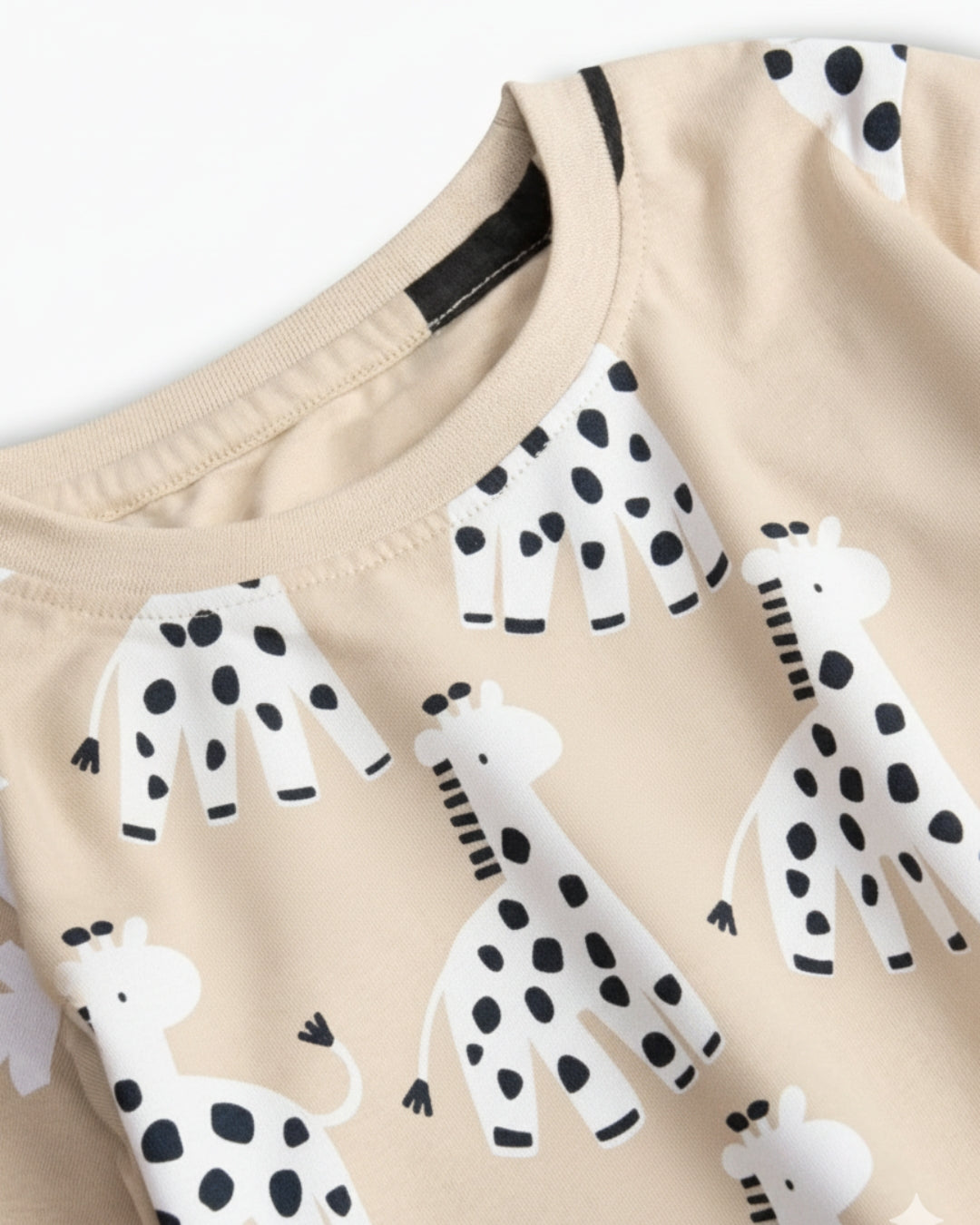 Beige fabric with black and white animal prints, including giraffes and dogs.
