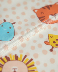 Close-up of fabric with cartoon animal designs on a polka dot background