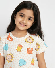Young girl wearing a shirt with colorful animal prints on a white background