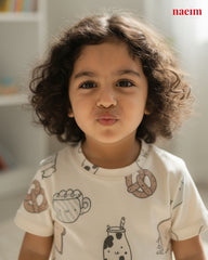Child wearing a shirt with food-themed designs in a casual setting