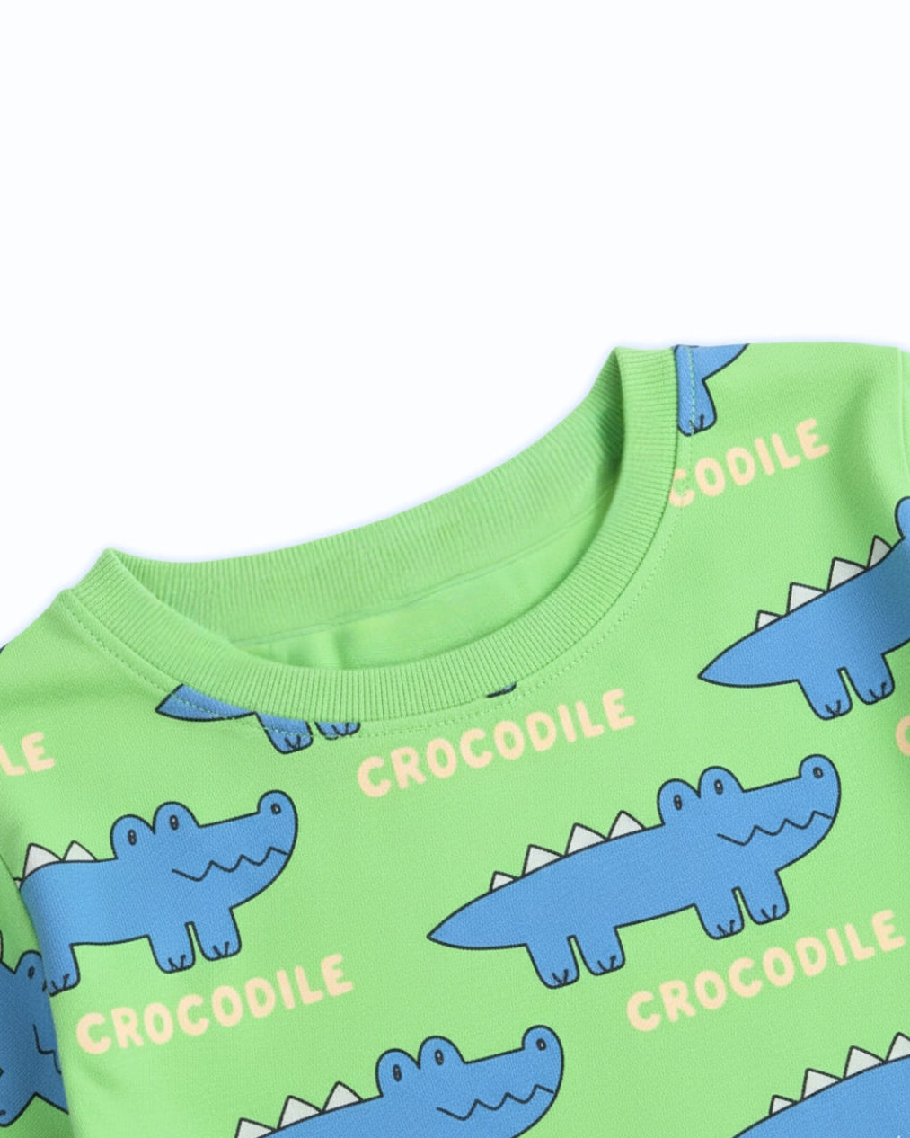 Green shirt with blue crocodile patterns and 'crocodile' text on a white background