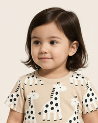 Child wearing a shirt with animal prints on a plain background