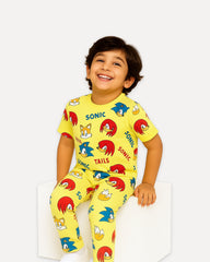 Child wearing a Sonic the Hedgehog-themed yellow outfit on a white background