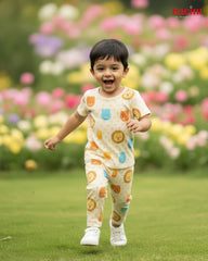 Child in a pajama with patterned outfit running in a garden with flowers in the background