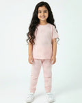 Young girl wearing a pink outfit on a white background