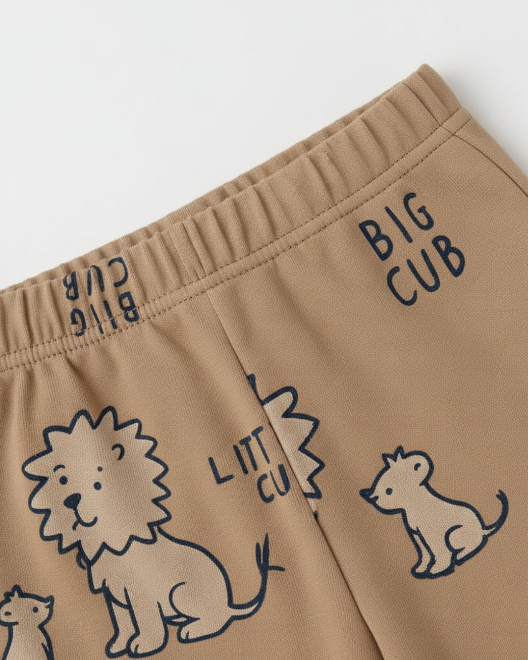 Brown shorts with lion illustrations and 'BIG CUB' text on a white background