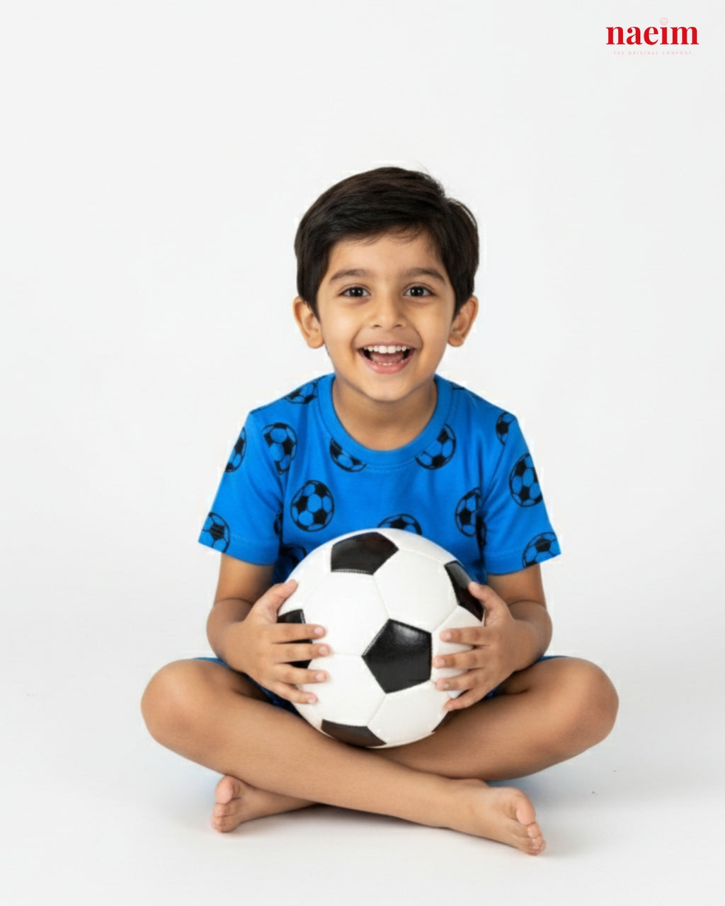 Child wear coord set holding a soccer ball on a white background