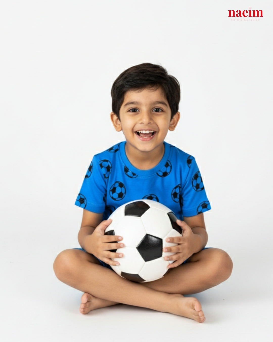 Child wear coord set holding a soccer ball on a white background