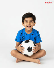 Child wear coord set holding a soccer ball on a white background