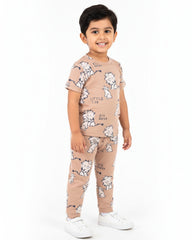 Child wearing a beige outfit with white dog prints on a white background