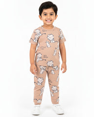 Child wearing a beige pajama set with animal prints on a white background