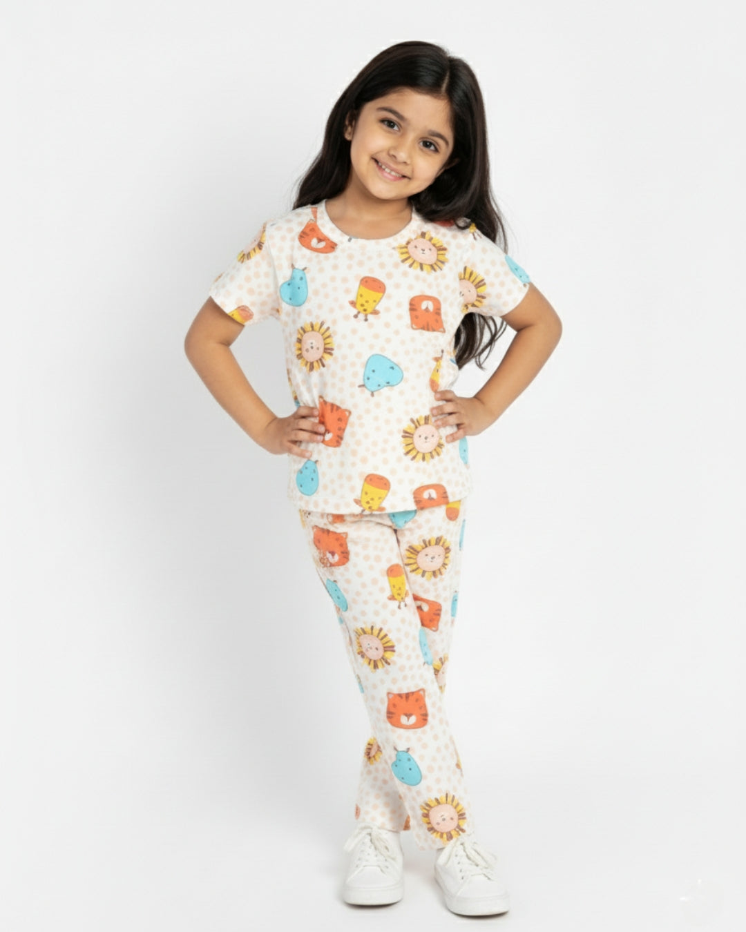 Young girl wearing a colorful pajama set with animal prints on a white background