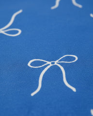 Blue fabric with white bow pattern