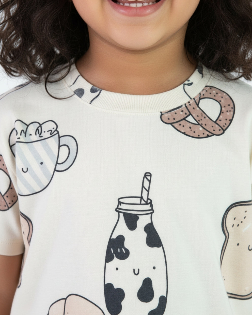 Child wearing a shirt with food-themed illustrations