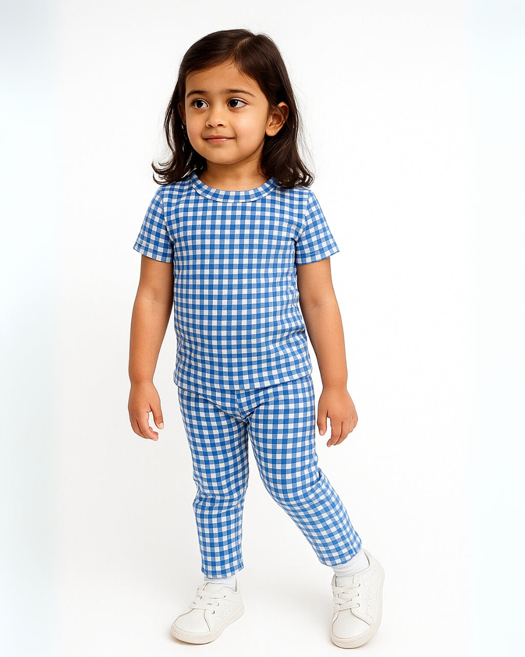 Child wearing a blue and white checkered outfit on a white background