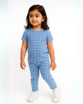 Child wearing a blue and white checkered outfit on a white background