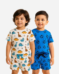 Two children wearing pajama sets with dinosaur and soccer ball patterns on a white background